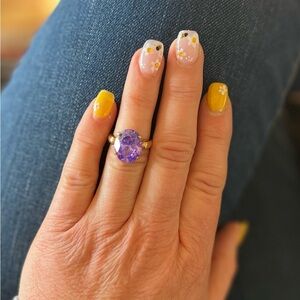 Vintage ring with multi faceted purple gemstone